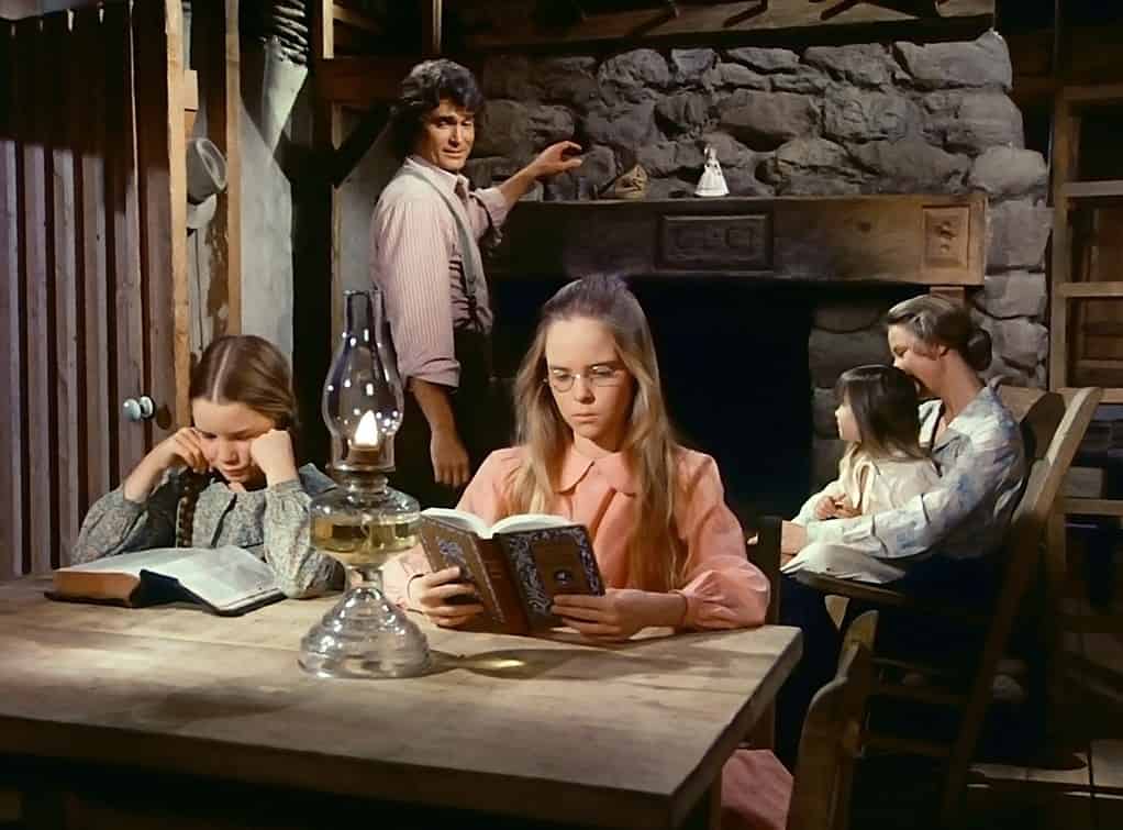 Inside the Ingalls home on little house and the prairie with Laura and Mary studying